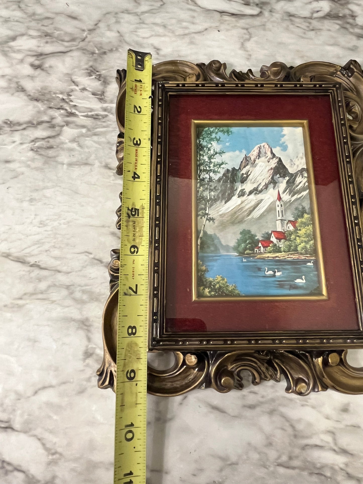 Ornate plastic frame with Church by lake print