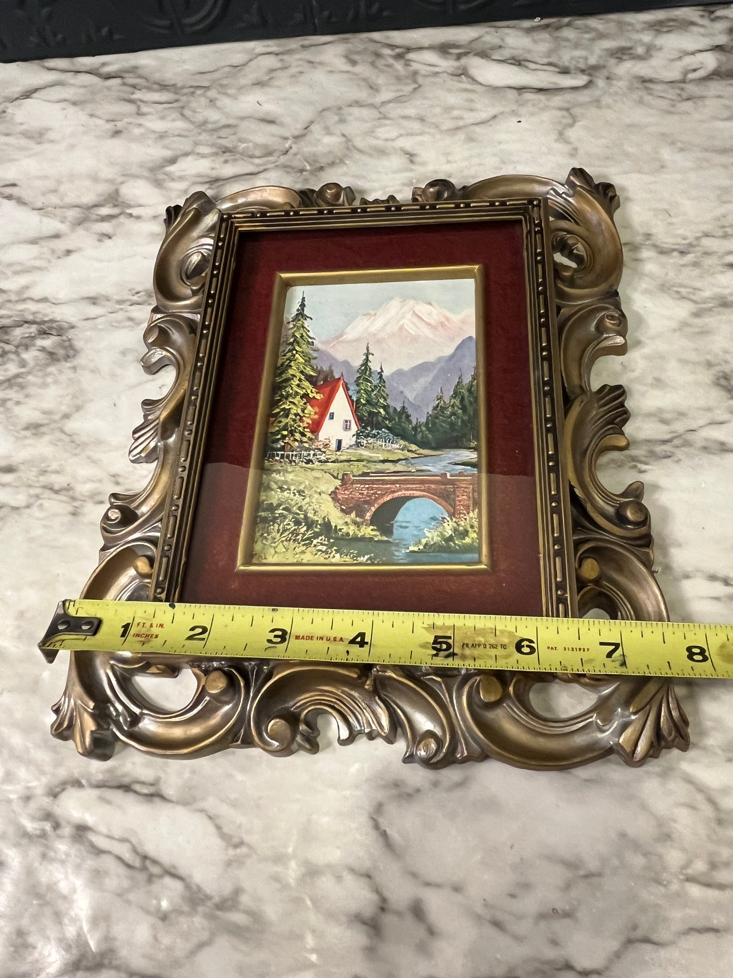 Ornate plastic frame with bridge print