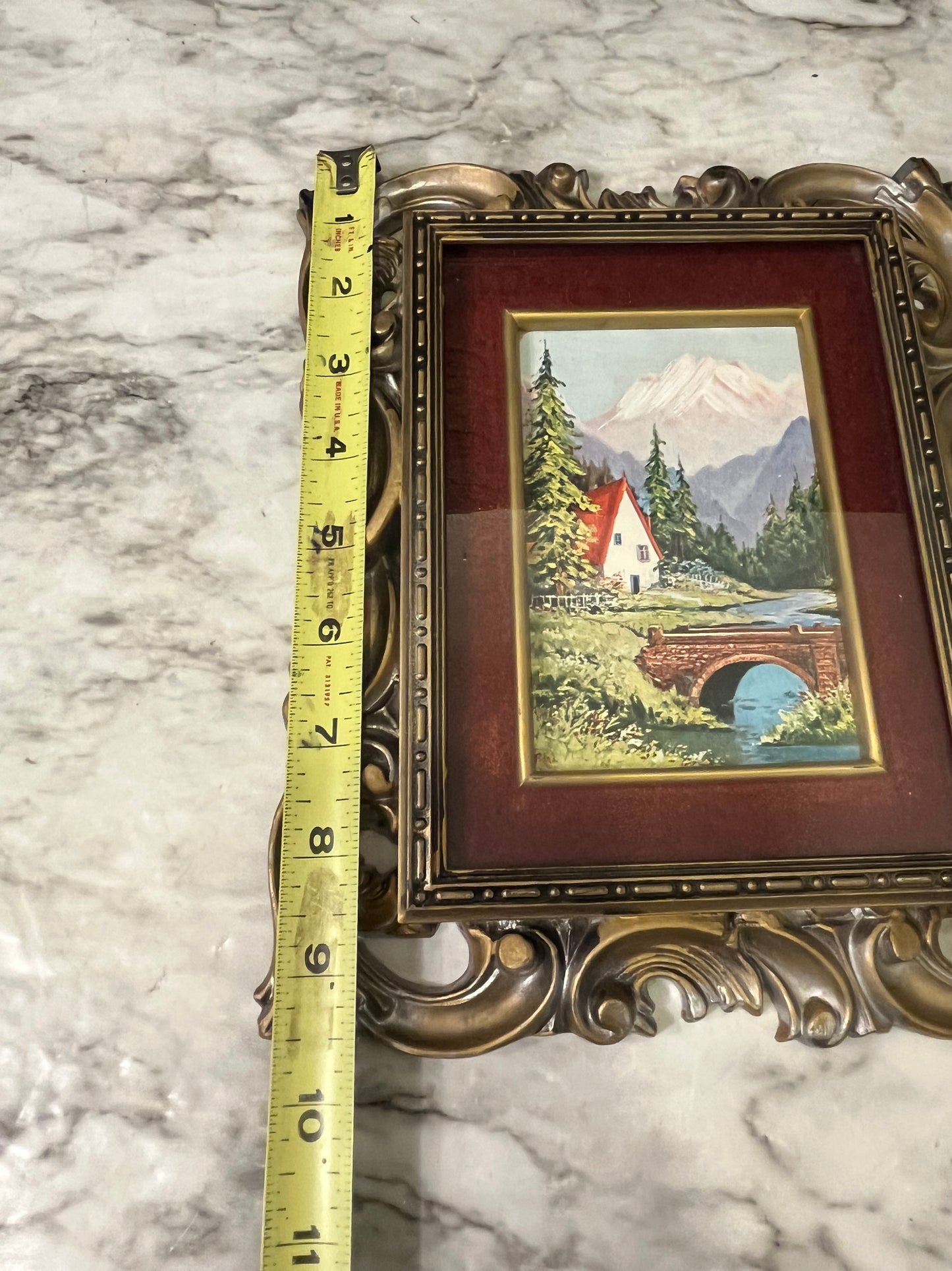 Ornate plastic frame with bridge print