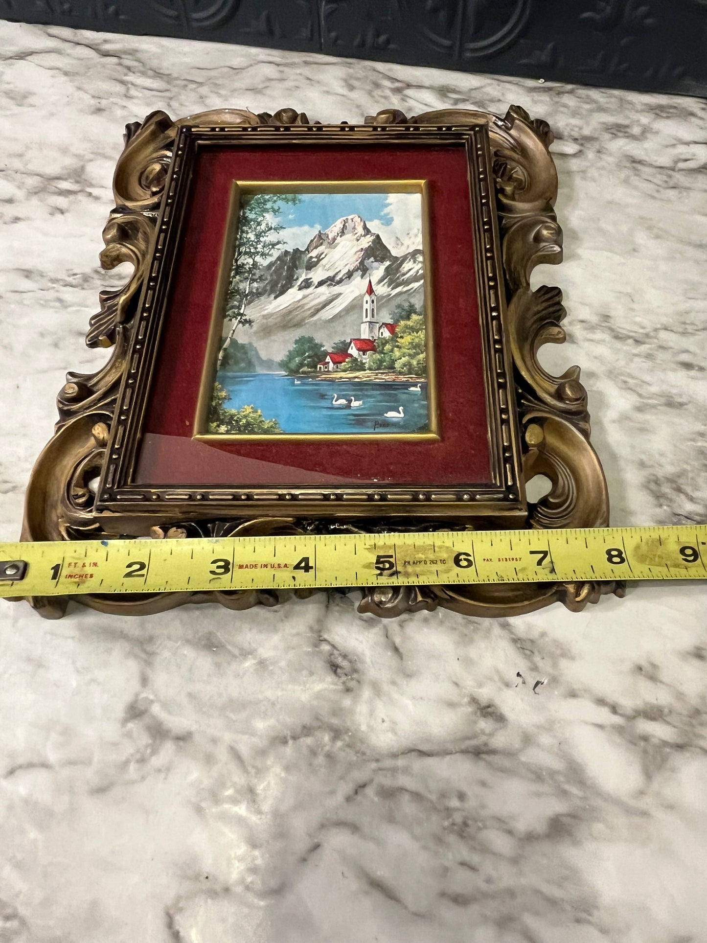 Ornate plastic frame with Church by lake print