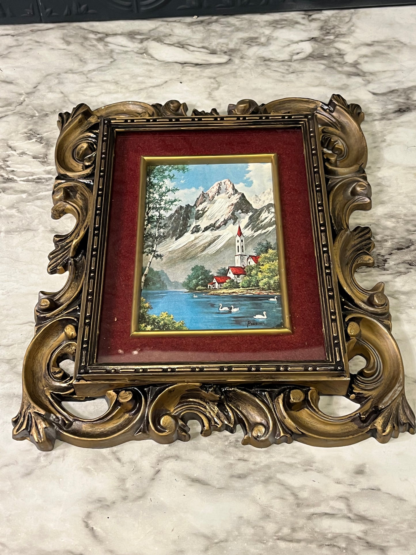 Ornate plastic frame with Church by lake print