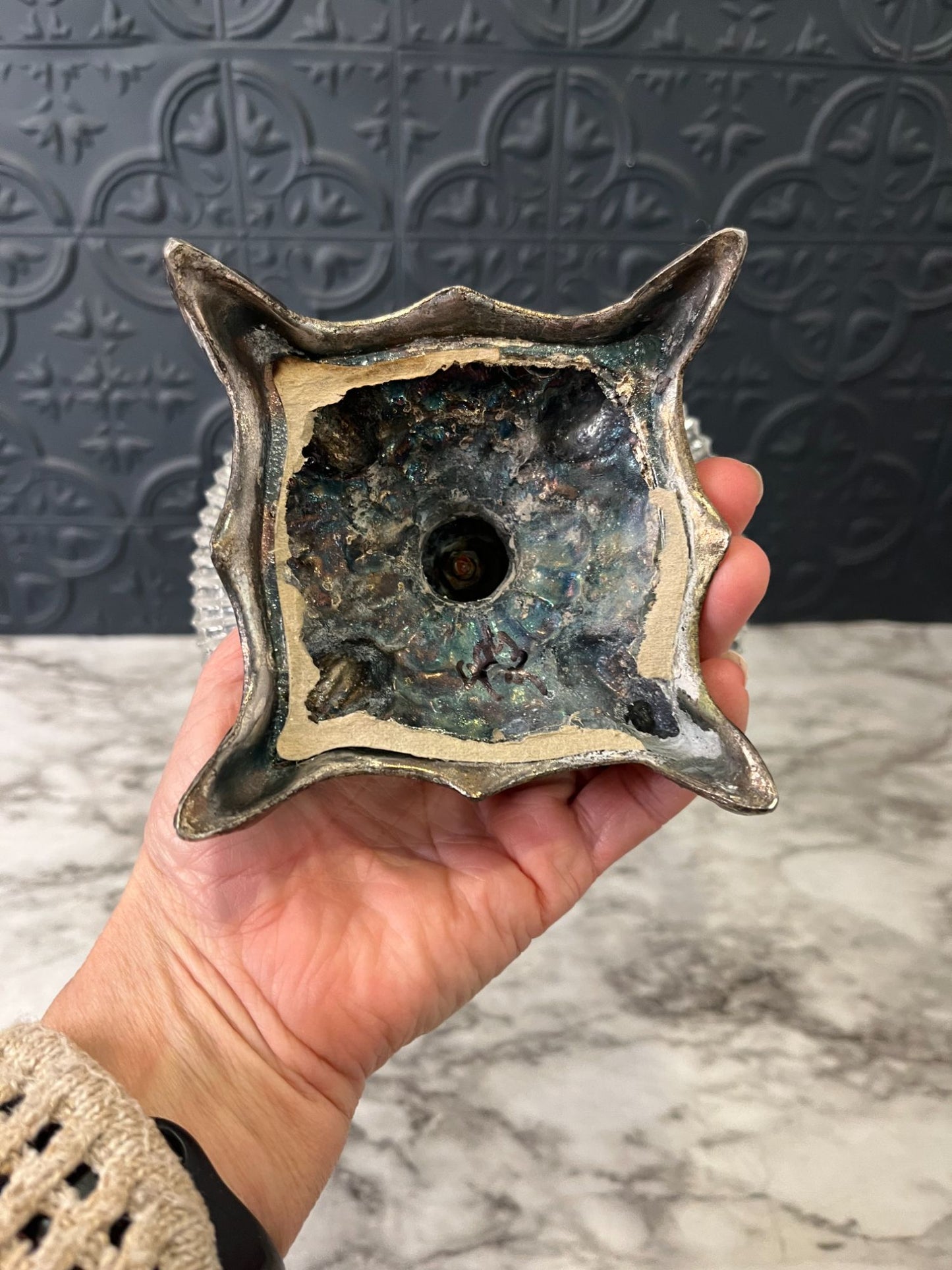 Glass pedestal dish on cast metal base