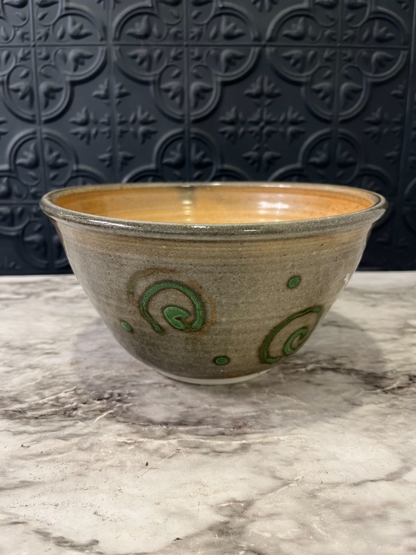 Pottery bowl with green swirls