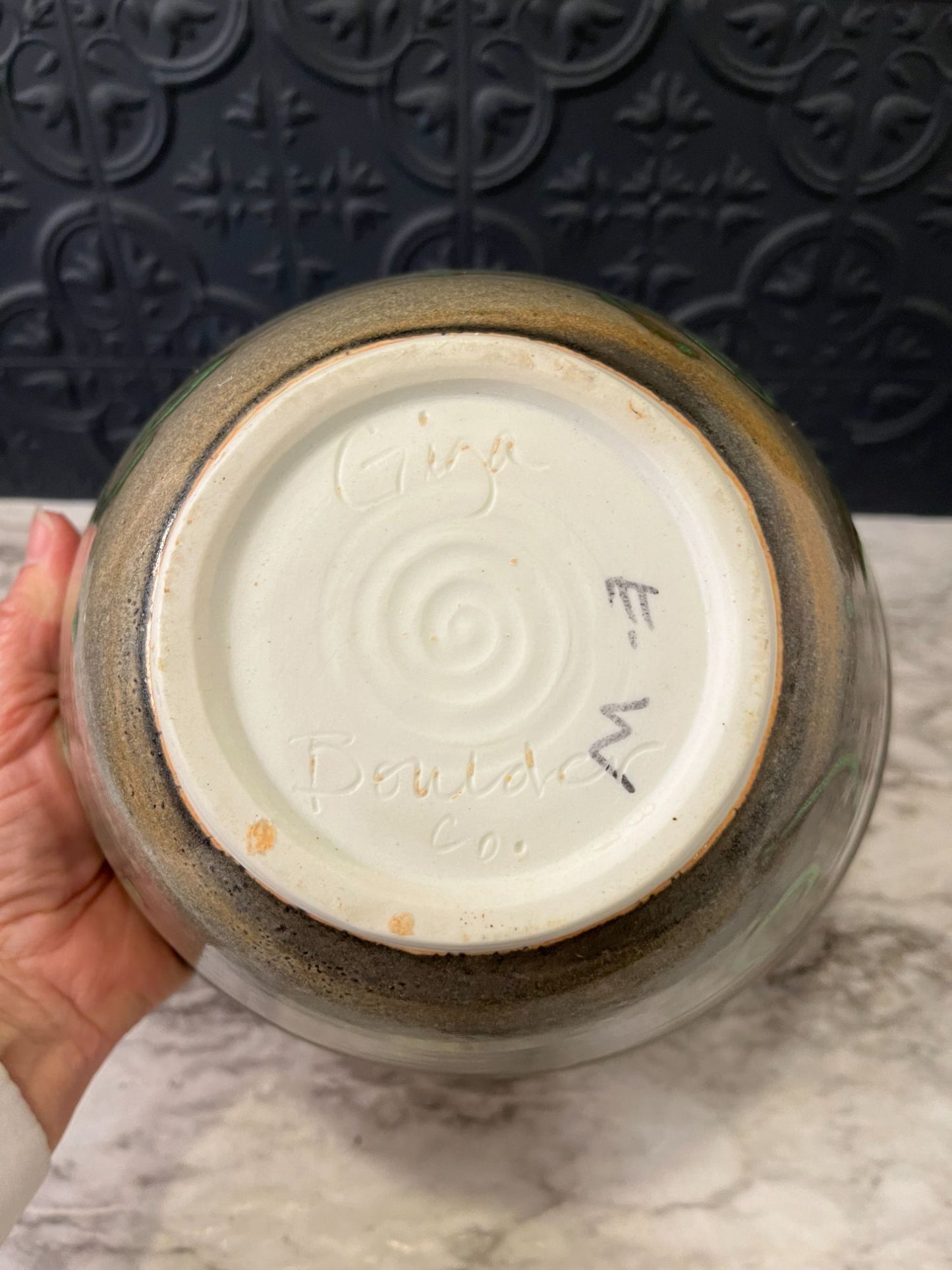 Pottery bowl with green swirls