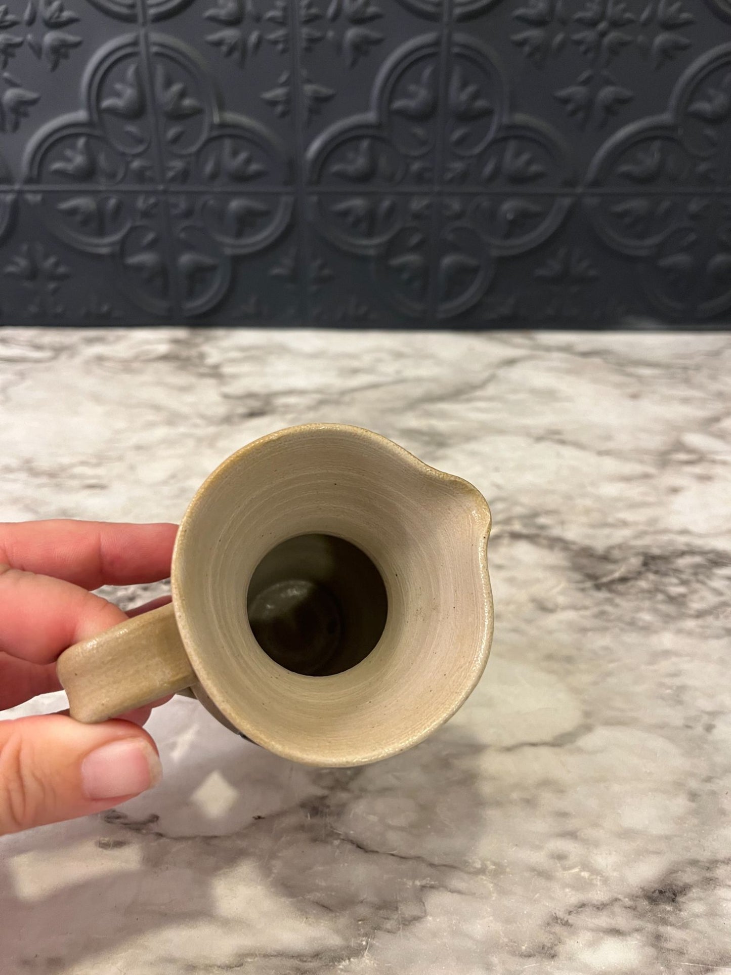 Small pottery pitcher with blue