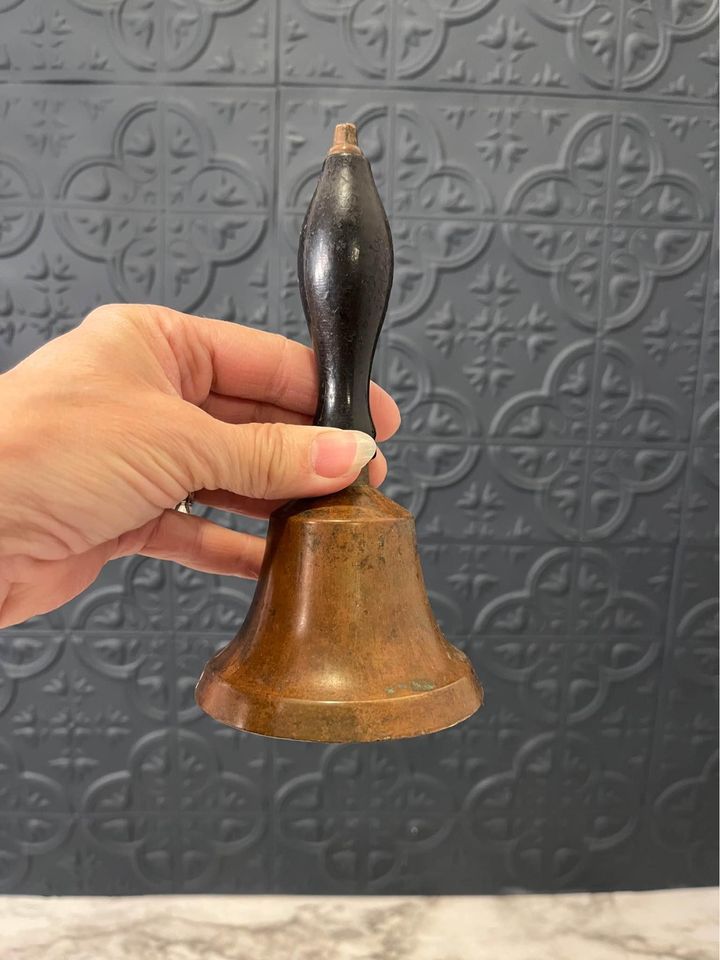 brass bell with black handle