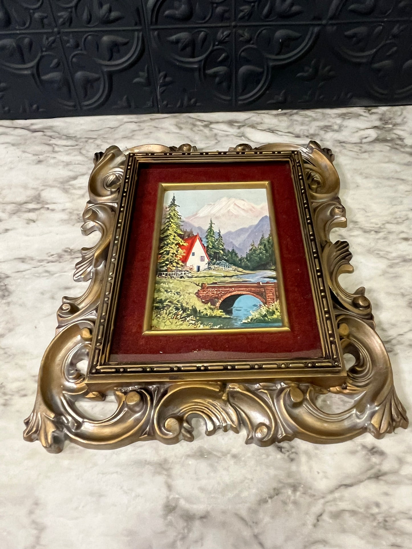 Ornate plastic frame with bridge print