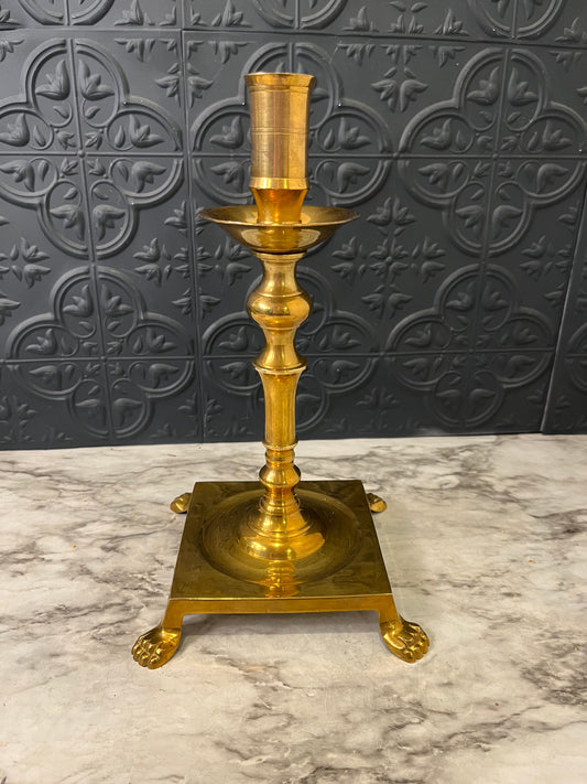 Brass candlestick with square base and feet