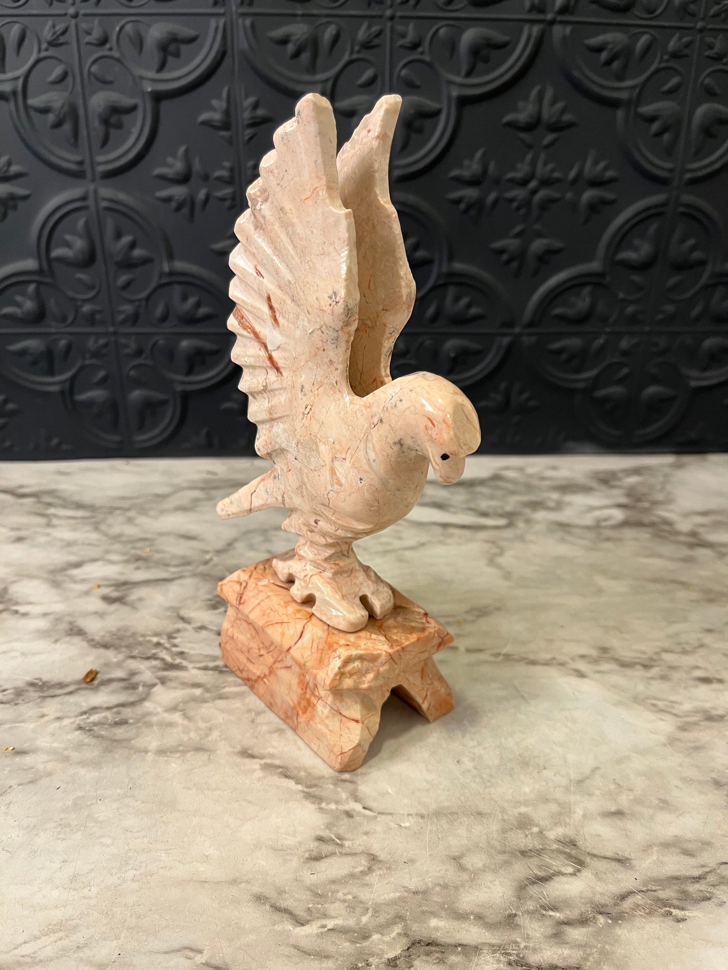 Carved pink stone bird
