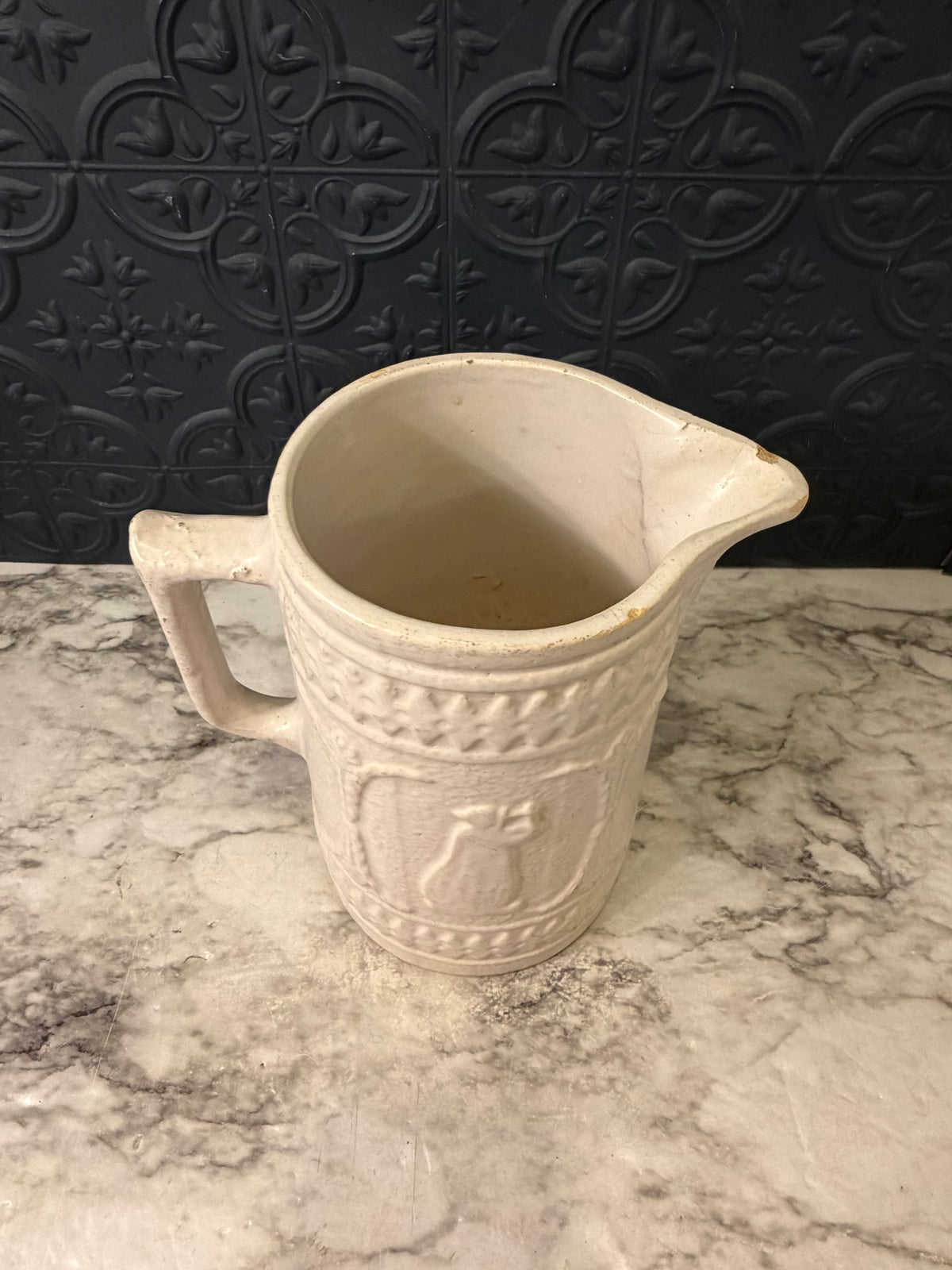 1920's Stoneware Pitcher with Relief RRP Co