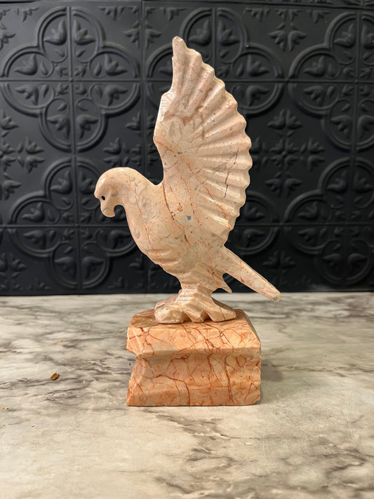 Carved pink stone bird