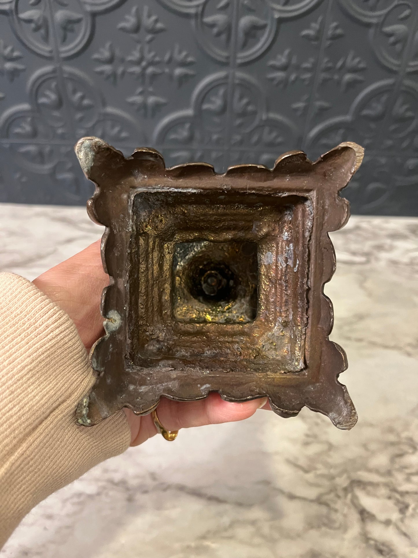 Green glass cup on cast metal base
