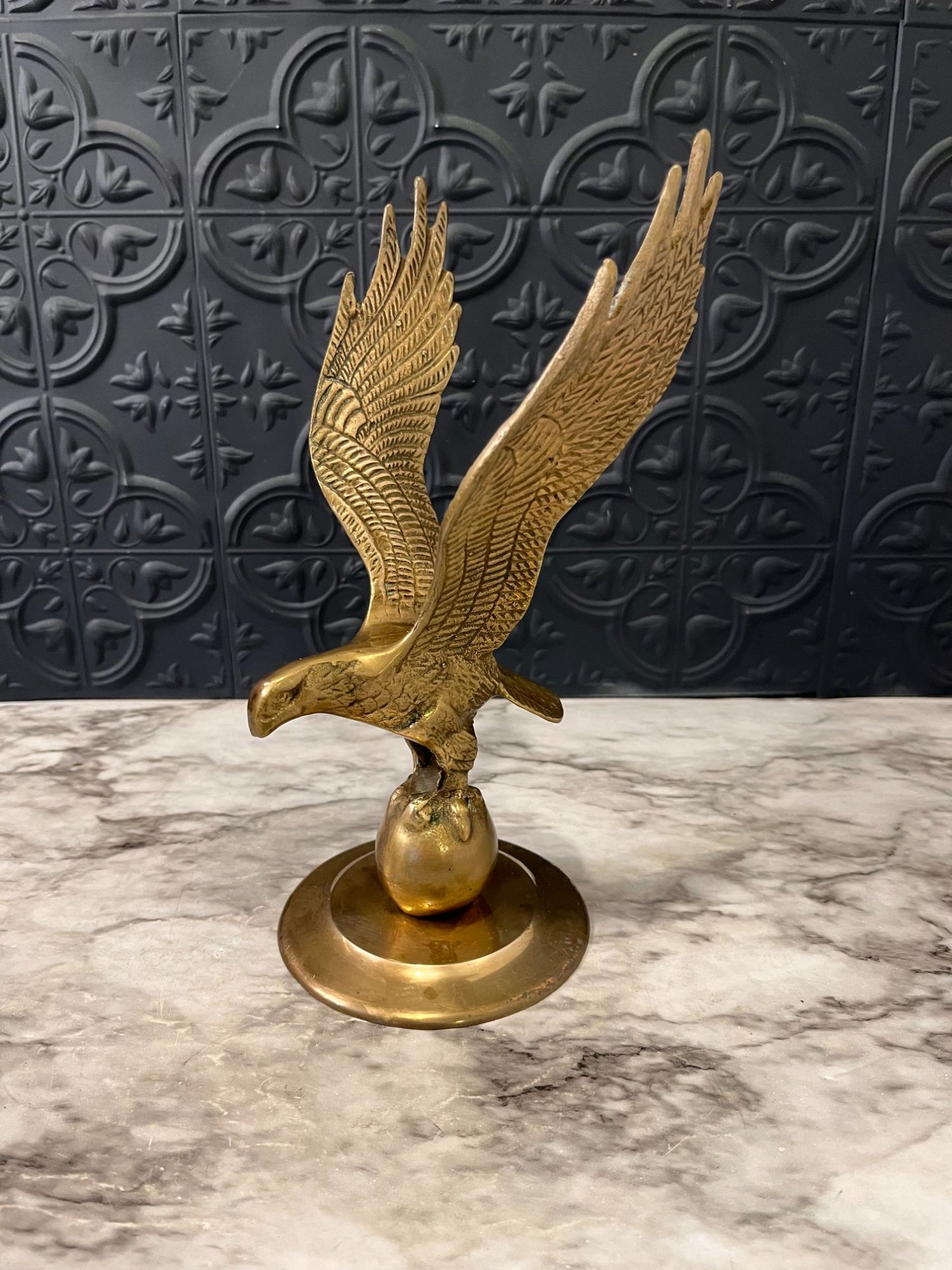 Brass eagle on ball