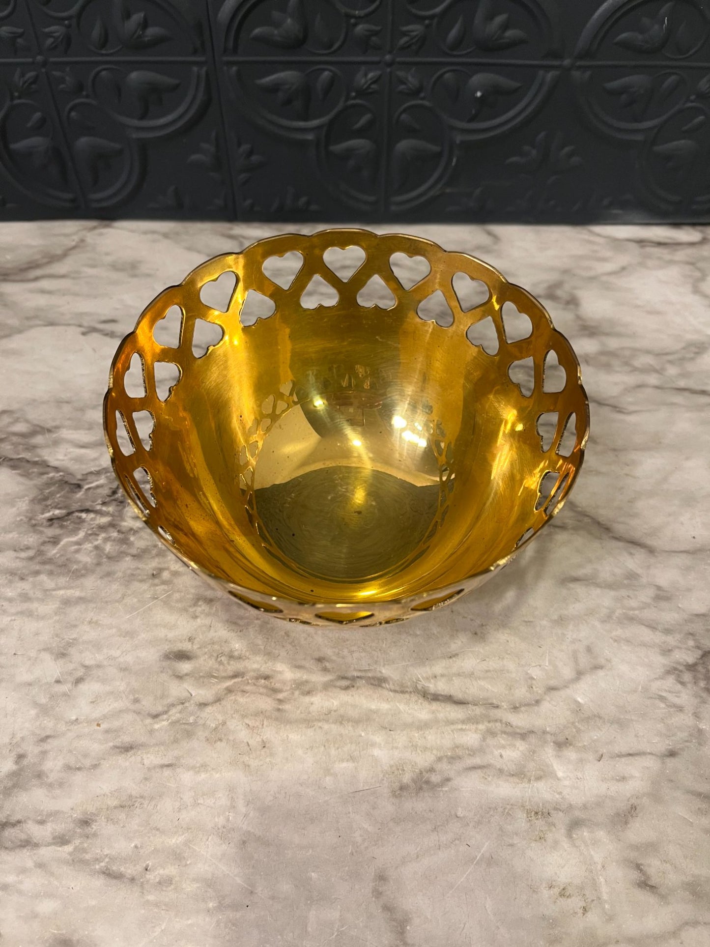 Brass bowl with heart cutouts