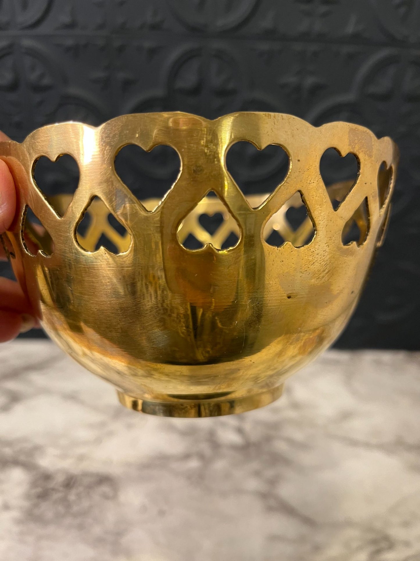 Brass bowl with heart cutouts