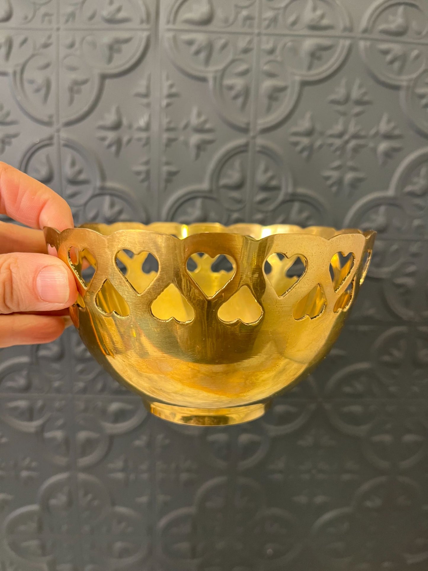 Brass bowl with heart cutouts