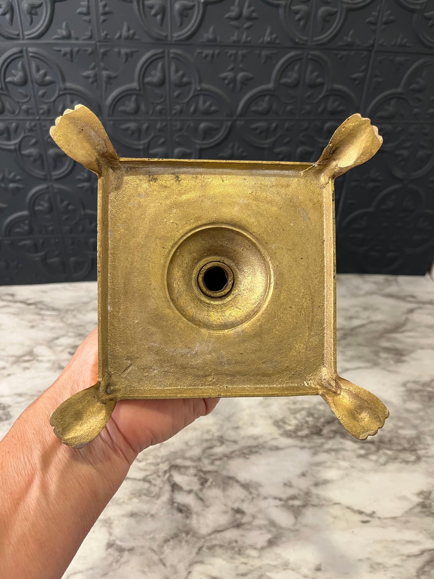 Brass candlestick with square base and feet