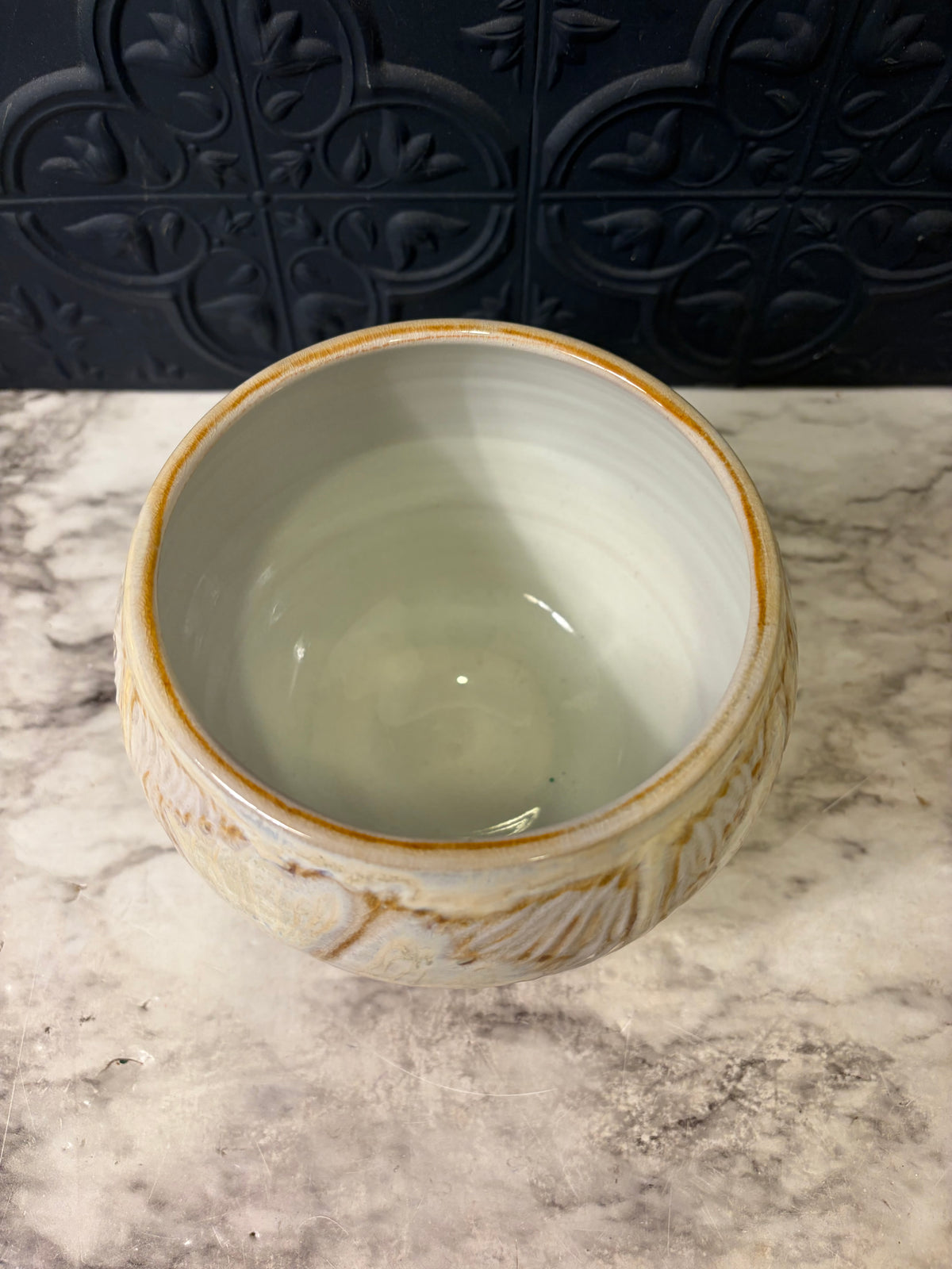 Cream Pottery Bowl With OrangE Swirl Design
