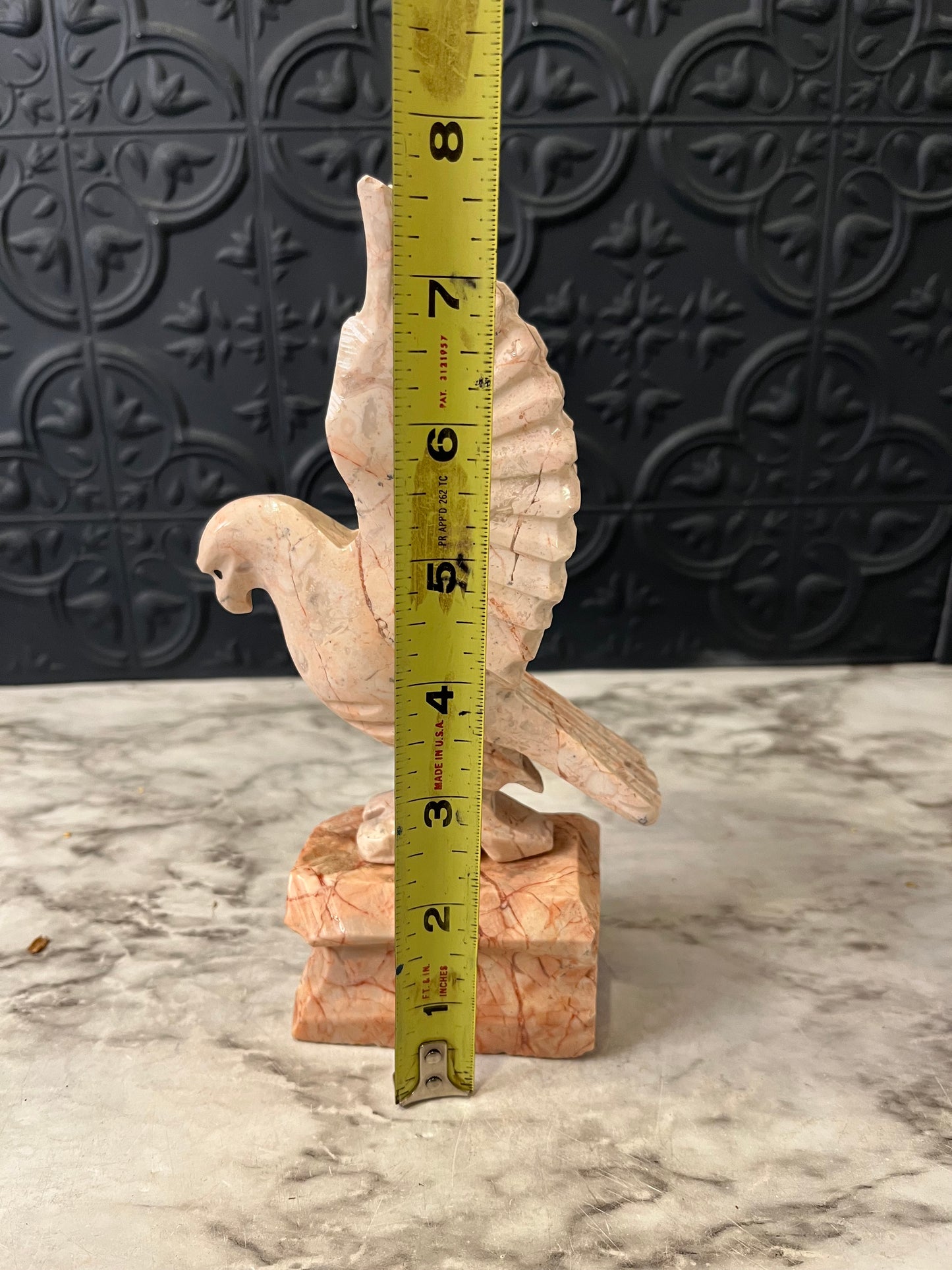 Carved pink stone bird