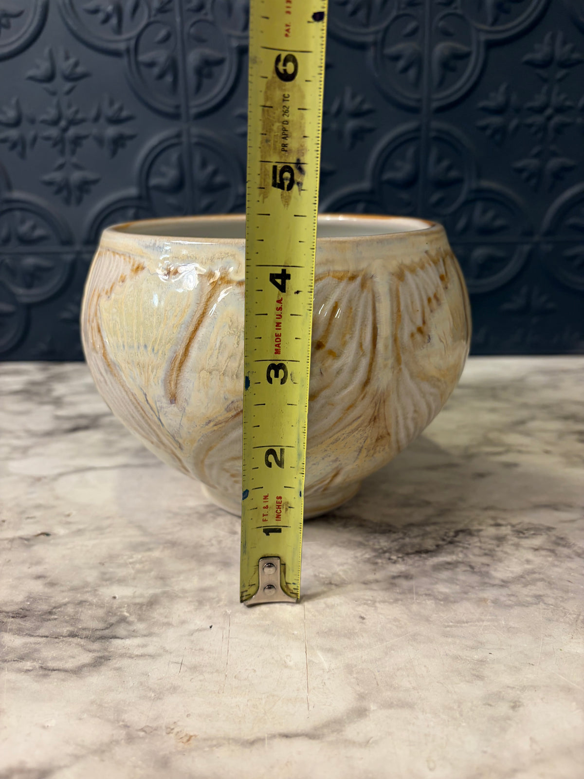 Cream Pottery Bowl With OrangE Swirl Design