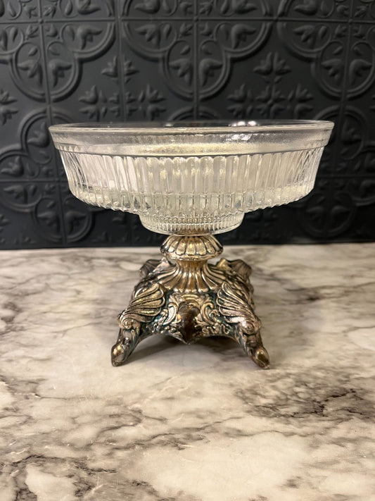 Glass pedestal dish on cast metal base