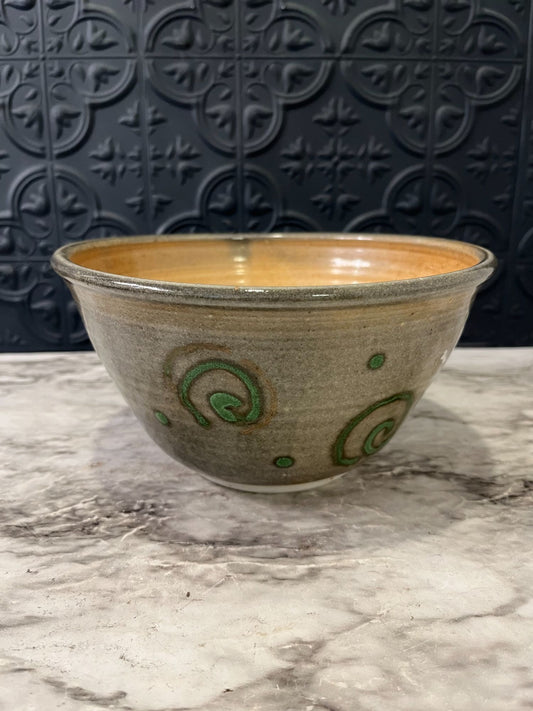 Pottery bowl with green swirls
