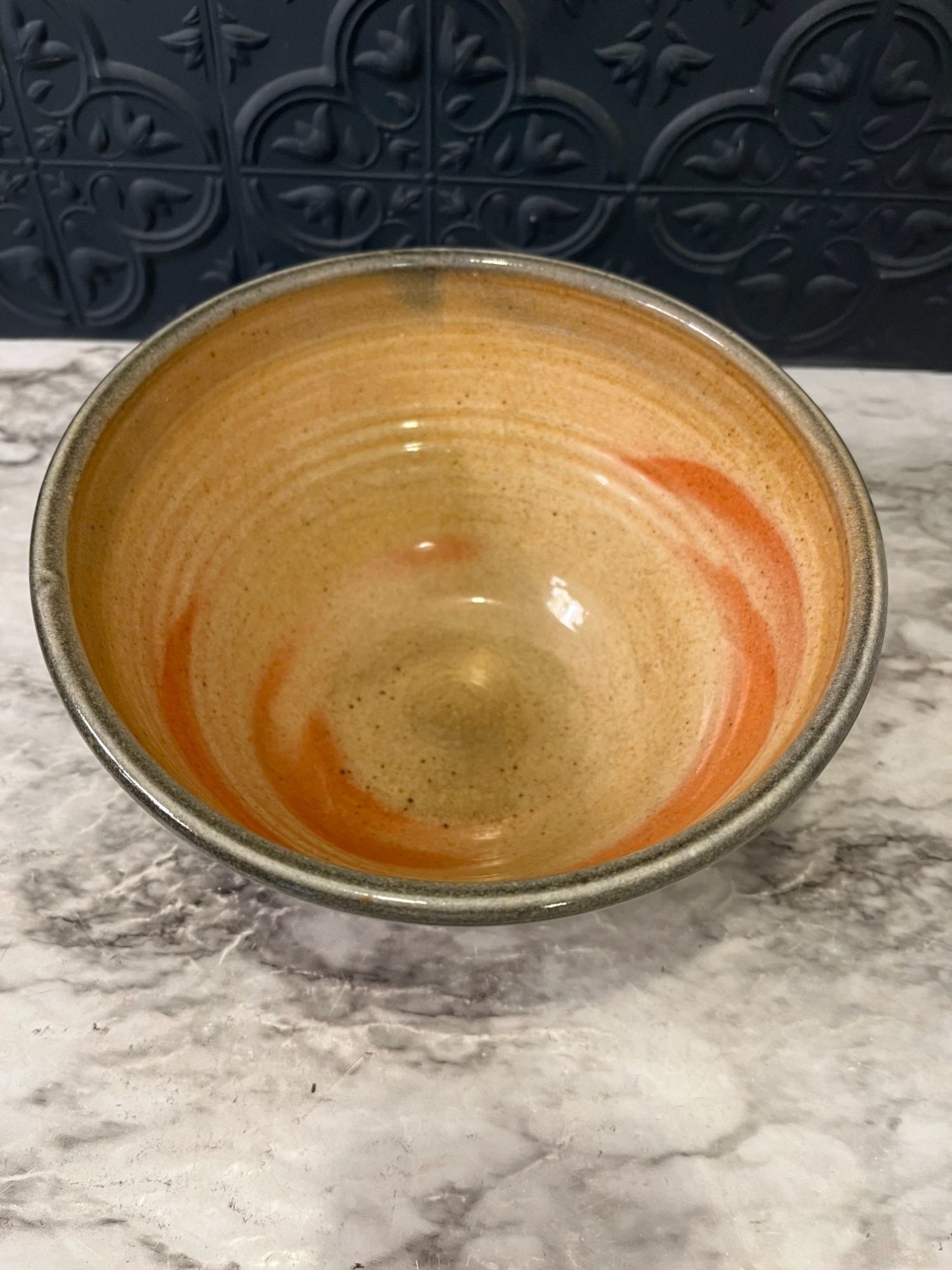 Pottery bowl with green swirls