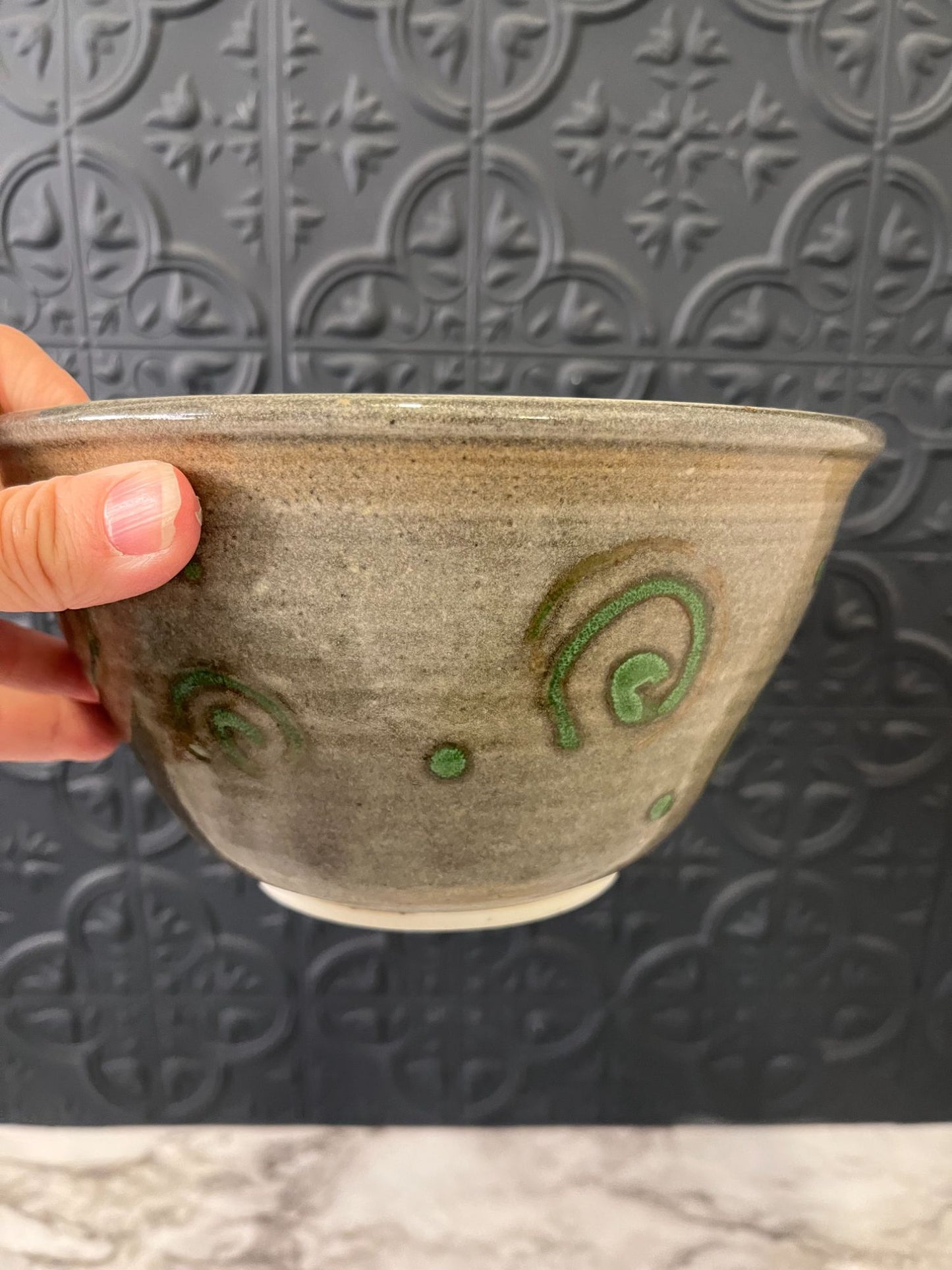 Pottery bowl with green swirls