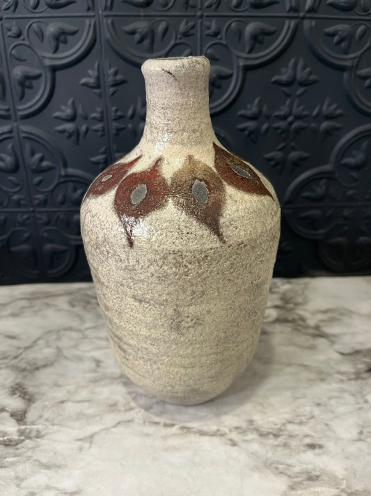 Pottery vase with leaf design around top