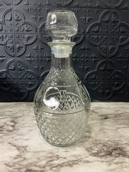 Clear glass decanter with grape and crown