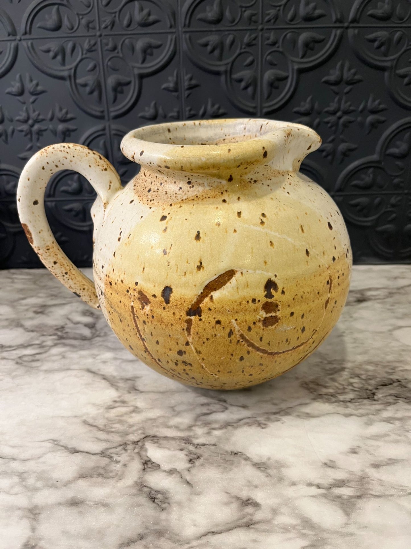 Round pottery pitcher with spots