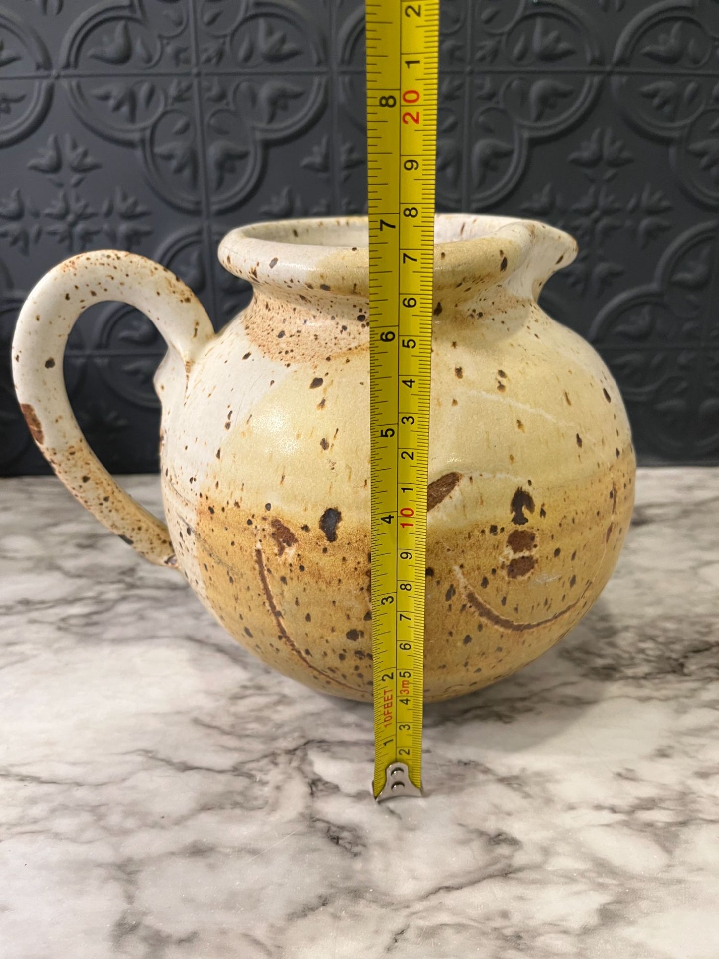 Round pottery pitcher with spots