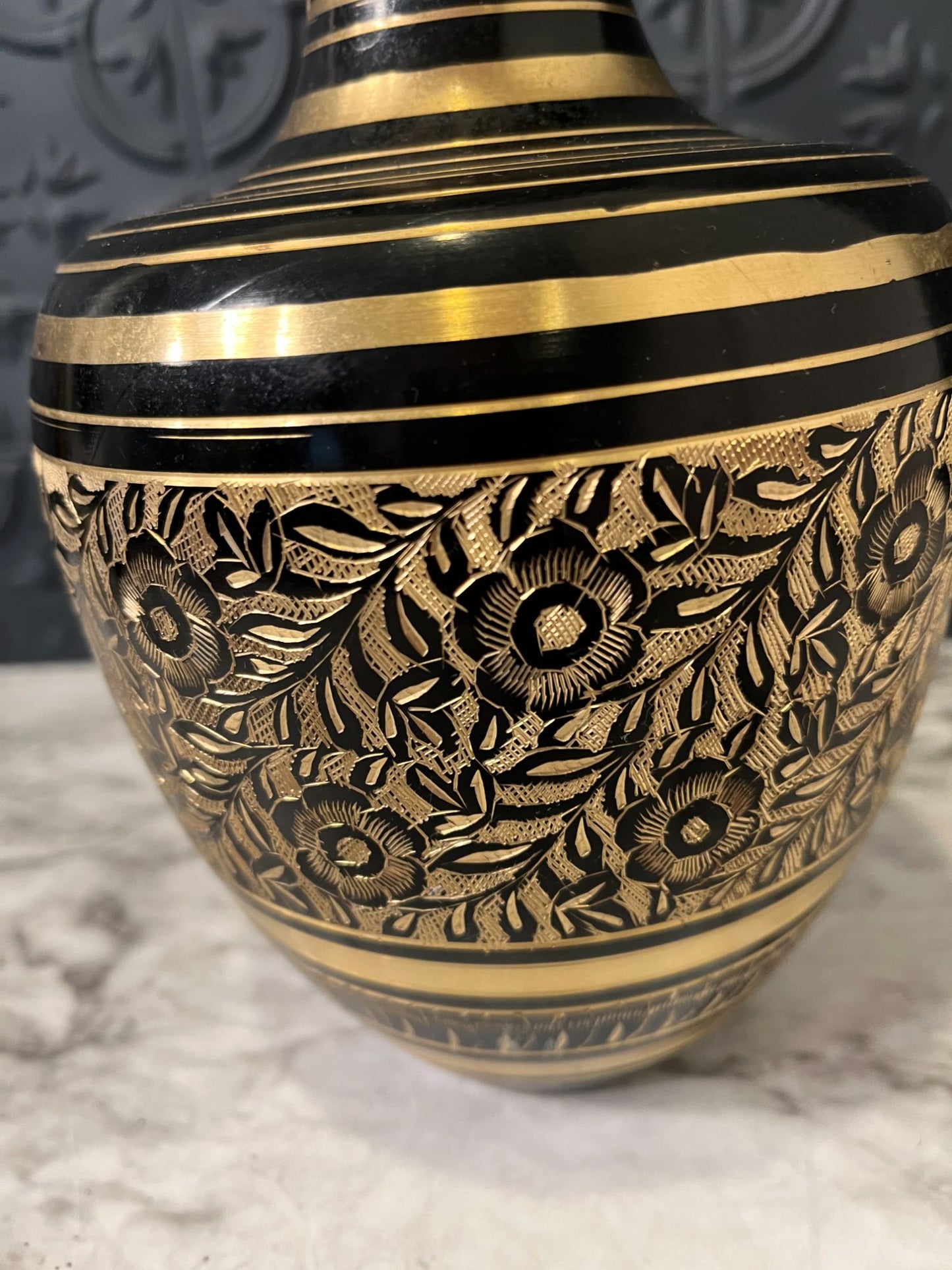 Brass and black etched vase with flowers