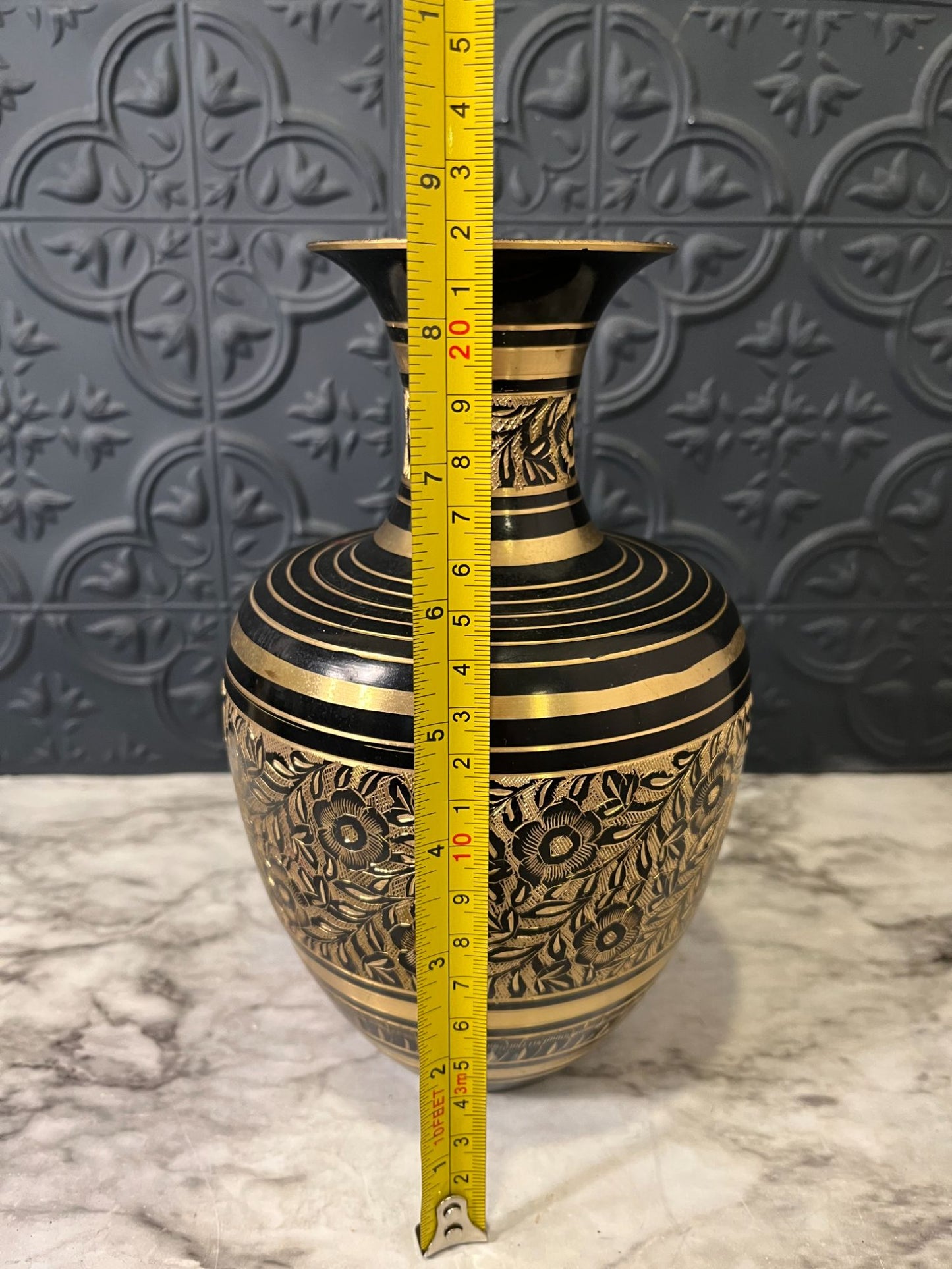 Brass and black etched vase with flowers