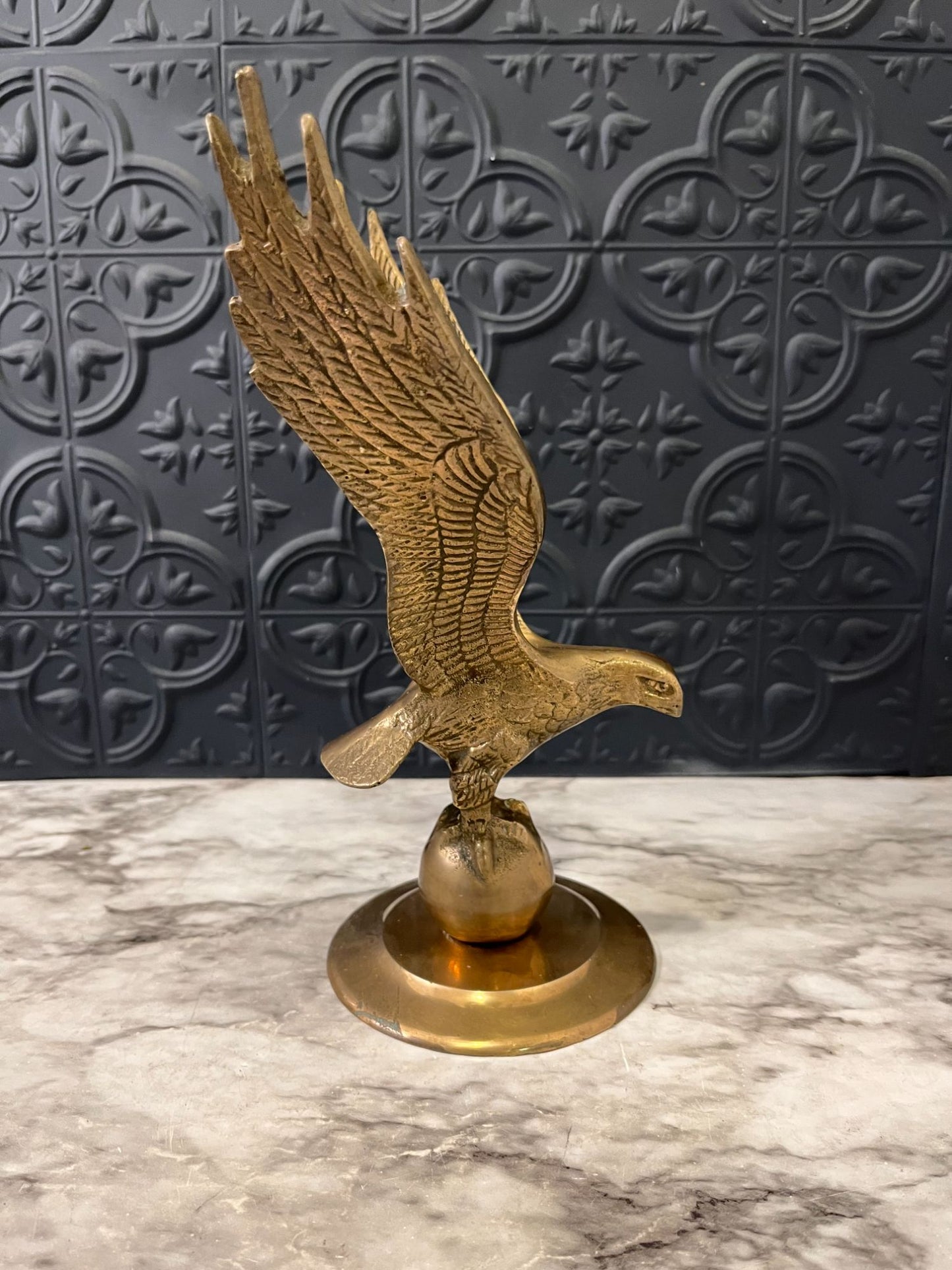 Brass eagle on ball