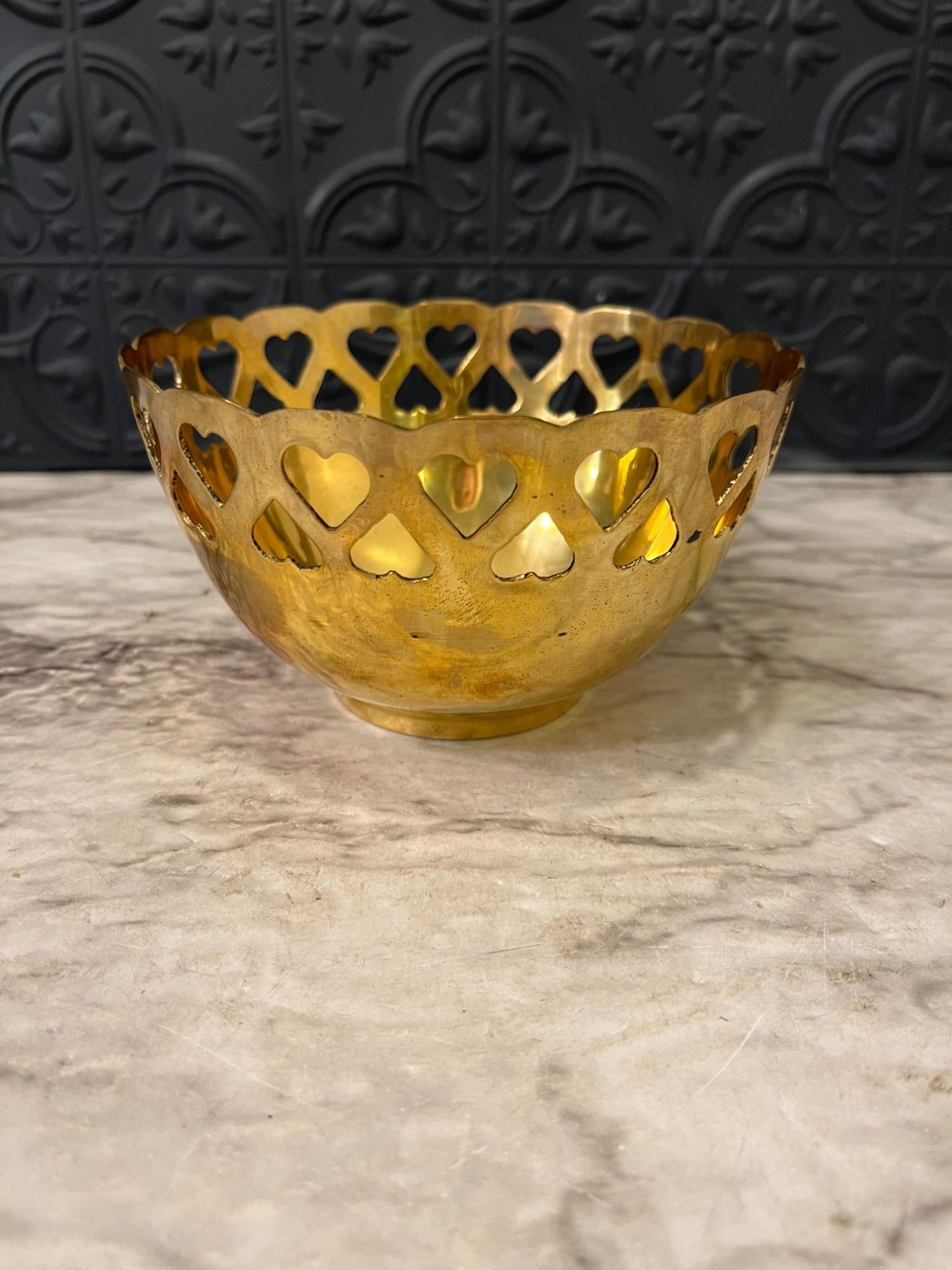 Brass bowl with heart cutouts