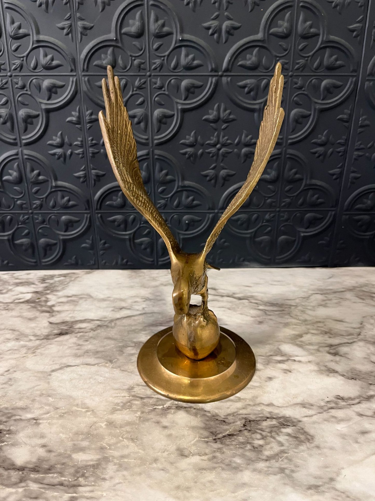 Brass eagle on ball