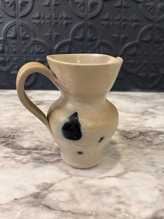 Small pottery pitcher with blue