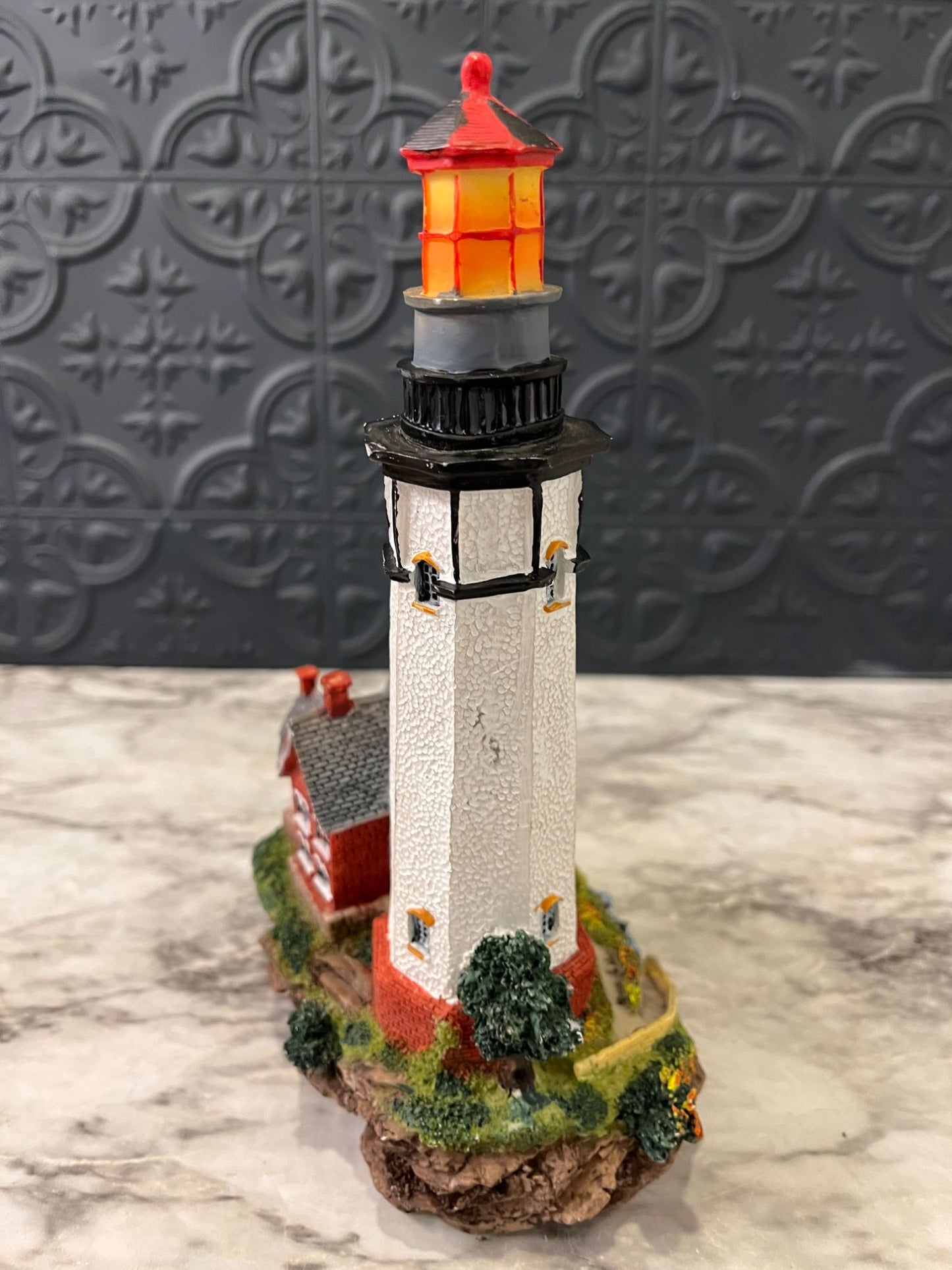 Lighthouse with red house